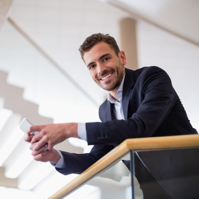 businessman-holding-mobile-phone_107420-67986.webp